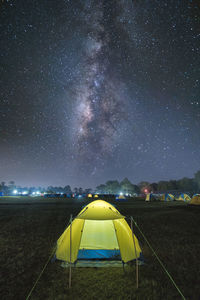 Tent on field against sky at night