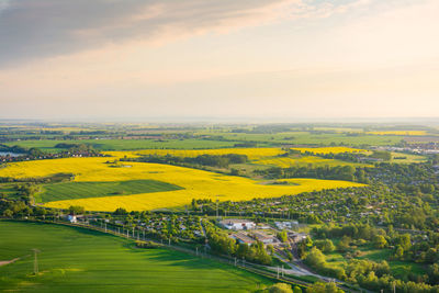 Scenic view of agricultural field against sky during sunset