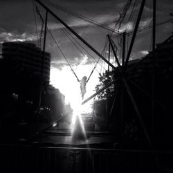 Low angle view of sun shining through clouds