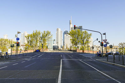 Road by city against clear sky