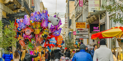 People on street against multi colored city