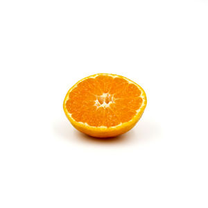 Close-up of orange slice against white background
