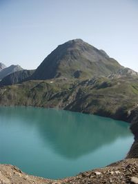 Scenic view of lake and mountains against clear sky