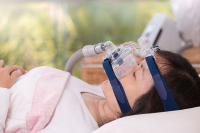 Side view of woman taking apnea treatment