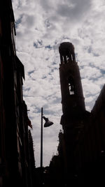 Low angle view of tower against cloudy sky