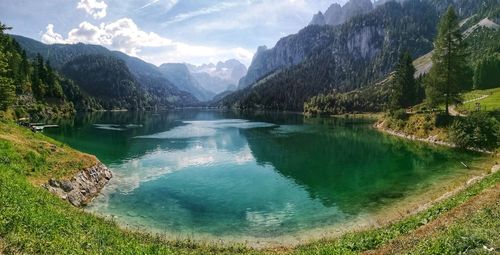 Scenic view of lake and mountains against sky