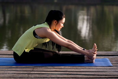 Full length of woman stretching outdoors