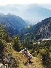 Scenic view of woman climbing rocks in a mountain at heini-holzer-klettersteig