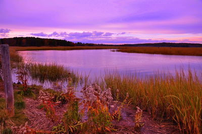 Scenic view of lake against sky at sunset