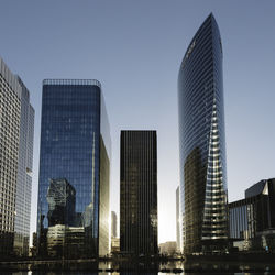 Low angle view of skyscrapers against clear sky