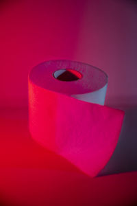 Close-up of pink candle against black background