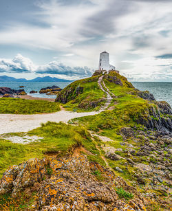 A cludy sunny day view of the twr mawr lighthouse in anglesey, wales, uk