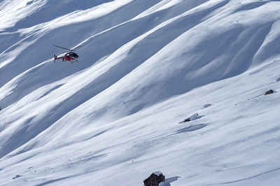 High angle view of people skiing on snowcapped mountain