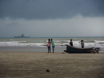 People on beach against sky