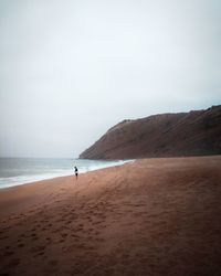 Scenic view of beach against clear sky