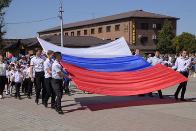 Group of people on street against buildings