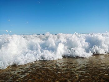 Scenic view of sea against clear blue sky