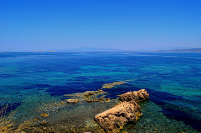 Scenic view of sea against clear blue sky