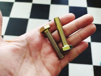 Close-up of human hand holding metal