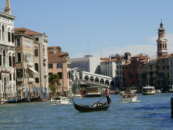 Boats in river with buildings in background