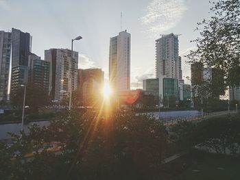 Skyscrapers in city at sunset