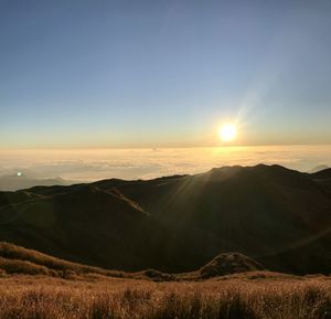 Scenic view of mountains against sky during sunset