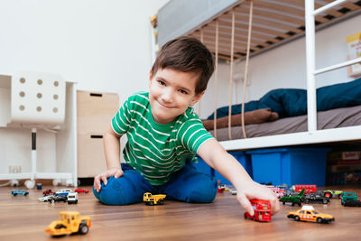 Portrait of boy playing with toy at home