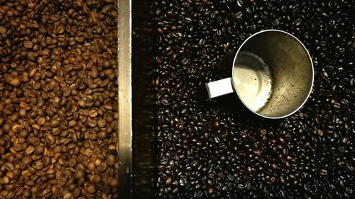 High angle view of container on roasted coffee beans