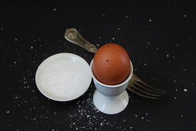 High angle view of boiled egg on black background