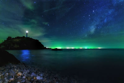 Long exposure photos. lighthouse star and the milky way at lanta island, krabi province, thailand.