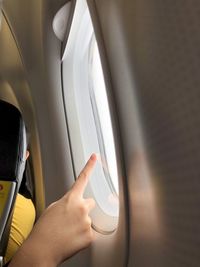 Close-up of person hand on airplane