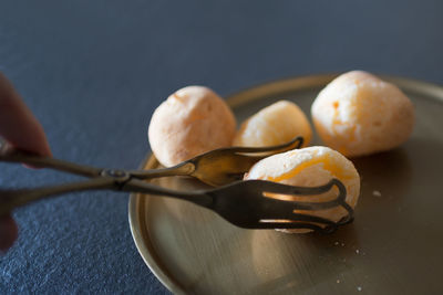 Close-up of hand holding ice cream on table