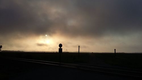 Silhouette of landscape against cloudy sky