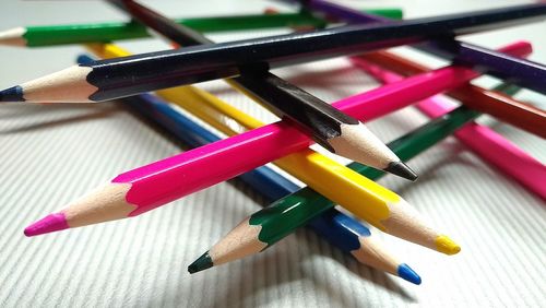 Close-up of multi colored pencils on table