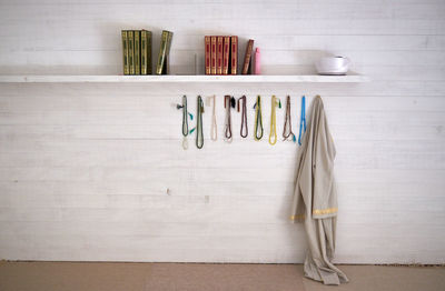 Korans with religious beads and clothing on wall