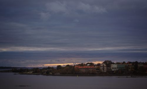 Scenic view of residential district and mountains against sky