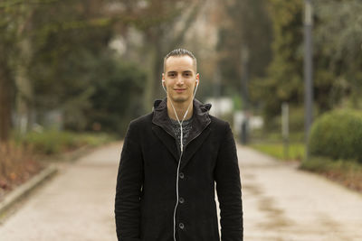 Portrait of smiling man standing against blurred background