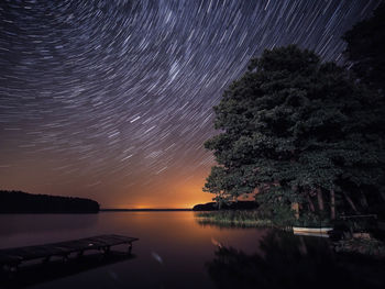 Scenic view of lake against sky at night