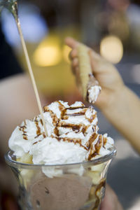 Close-up of hand holding ice cream