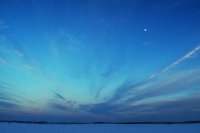 Scenic view of sea against blue sky at night