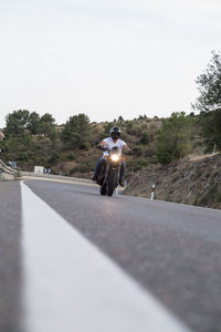 Man riding motorcycle on road