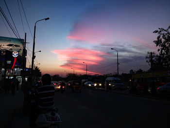 Cars on road at sunset
