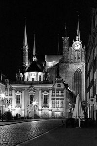 View of illuminated buildings against sky at night