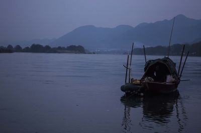 People sitting on boat in lake