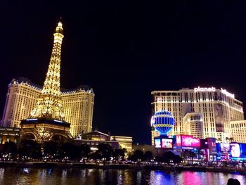 Low angle view of illuminated building against sky at night