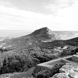 Scenic view of sea and mountains against sky