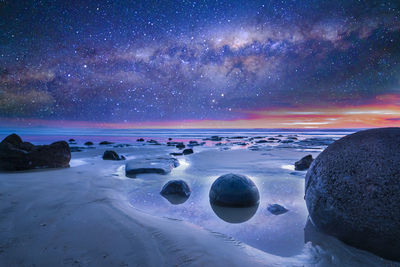 Scenic view of sea against sky at night