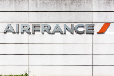 Low angle view of text on white wall