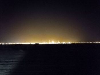 Silhouette landscape against sky at night