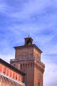 Low angle view of building against cloudy sky